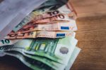 aus einem Umschlag schauen einige Euro-Banknoten heraus